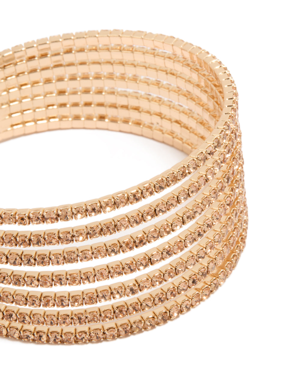 Highlighting a gold diamante layered wrist cuff featuring a statement bangle design in tan close up view