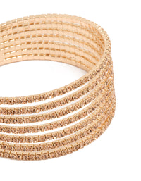 Highlighting a gold diamante layered wrist cuff featuring a statement bangle design in tan close up view - link has visual effect only