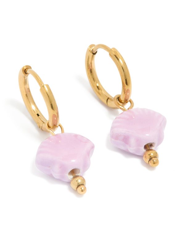 These gold plated stainless steel huggie earrings feature pink shell in an ocean-inspired design front view