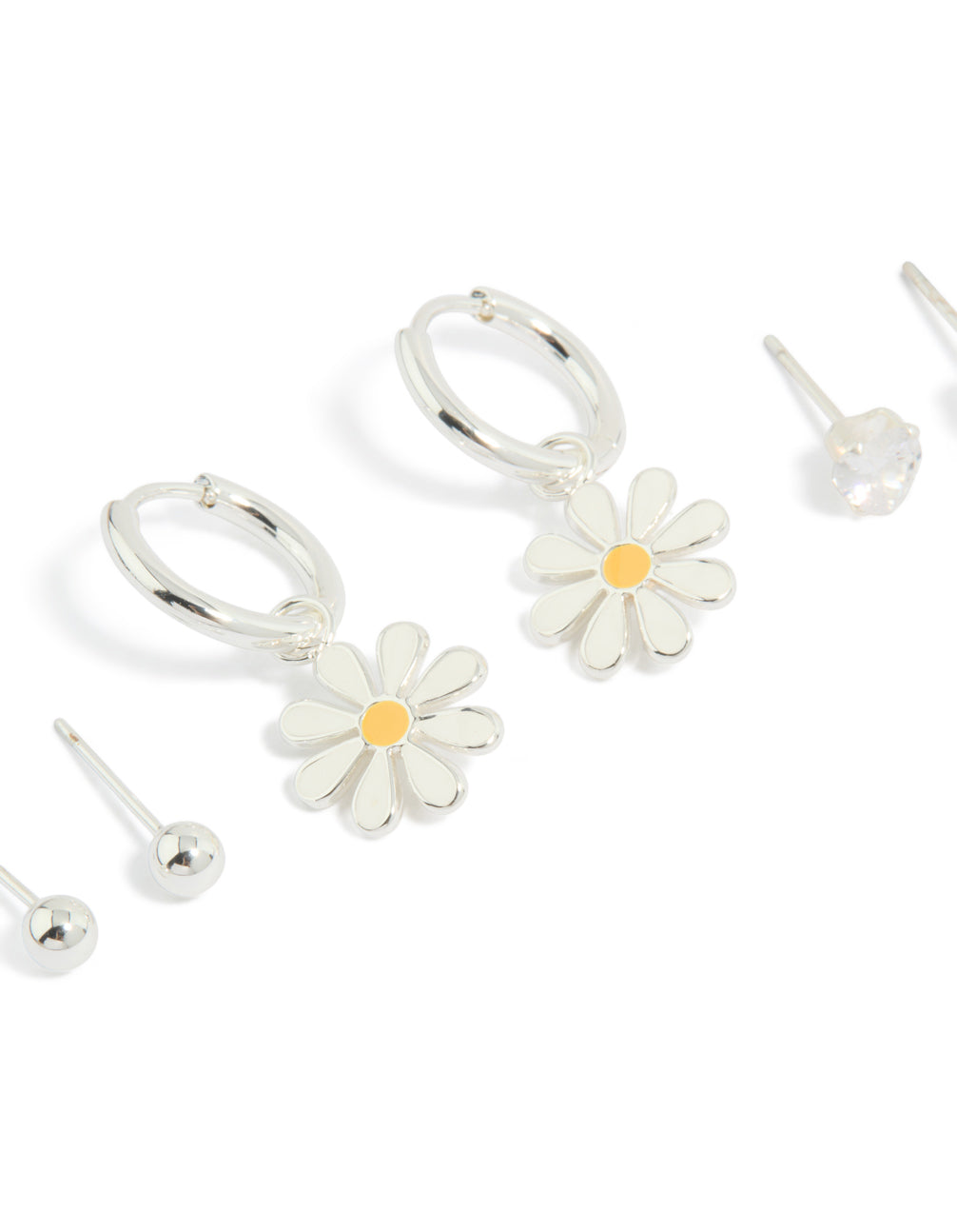 Featuring stainless steel heart and daisy floral and ball stacking earrings in a 3-pack with waterproof design, stud and huggie closures, silver, white, and gold tones close up view