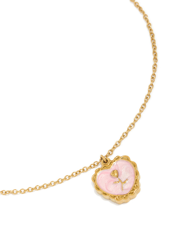 Showcasing a dainty charm with floral and heart design, crafted from enamel, gold plated waterproof stainless steel featuring pendant in light pink on neck view