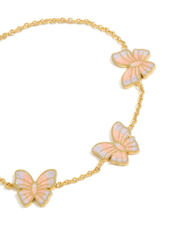 Featuring a tweens butterfly charm bracelet with glitter enamel accents, crafted from waterproof gold plated stainless steel in pink and lavender close up view
