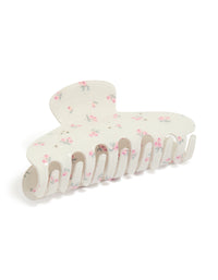 Showcasing a white acrylic claw clip with floral diamante pink flowers and light green accents side view - link has visual effect only