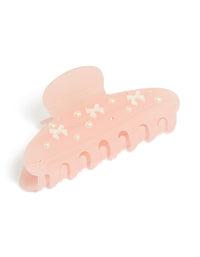 Showcasing a tweens hair claw clip with bow, pearl, and charm accents in solid pink, ivory, and white front view - link has visual effect only
