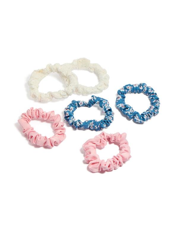 Showcasing a set of six tweens scrunchies featuring floral print in light pink sky blue ivory and white front view