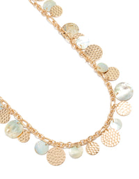 Showcasing a statement necklace with charm ocean elements featuring shell in gold close up view - link has visual effect only
