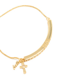 Highlighting a gold plated cubic zirconia faith toggle bangle with charm cross and script detail close up view - link has visual effect only