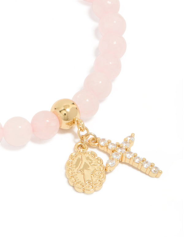 Discover a gold plated cubic zirconia Mary cross rose quartz beaded bracelet with charm and crystal close up view