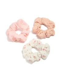 Featuring pink and white mixed floral fabric scrunchies in a 3-pack front view - link has visual effect only