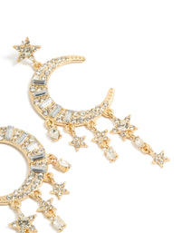 Showcasing diamante statement drop earrings featuring celestial charm elements in gold post detail view - link has visual effect only