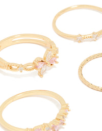 Detailed view of gold pink and clear cubic zirconia flower rings 5-pack with butterfly featuring crystal in white close up view - link has visual effect only