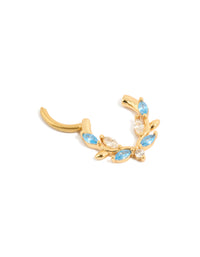 Featuring a gold plated titanium clicker ring with clear blue cubic zirconia stones detail view - link has visual effect only
