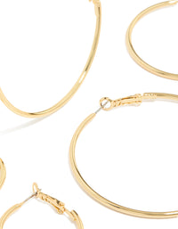 Showcasing gold plated small and medium hoop earrings with closure detail in a 3-pack close up view - link has visual effect only