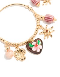 Crafted gold brown heart and sun charm hoop earrings featuring floral beads, celestial design and striped pattern in close up view - link has visual effect only