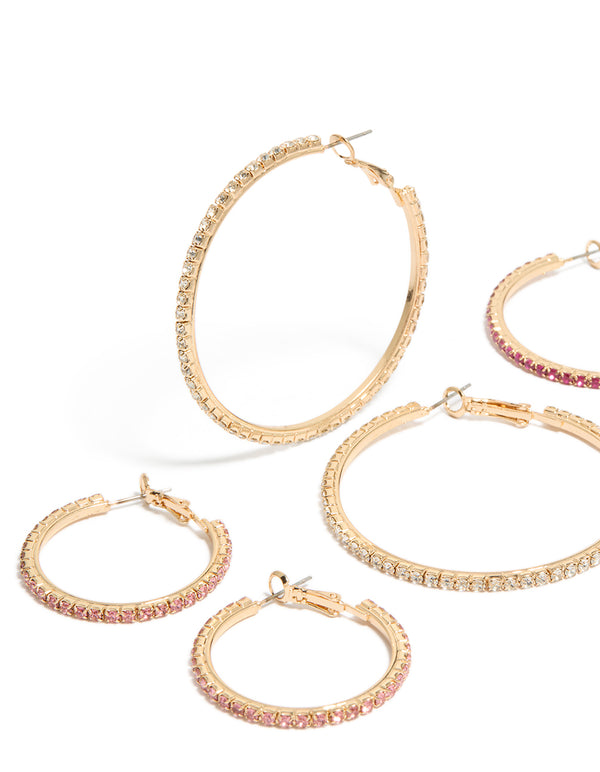 Featuring gold clear and pink diamante mixed size hoop earrings in a 3-pack close up view