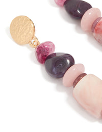 Showcasing textured metal disc and colorful beaded detailing on these chunky earrings close up view - link has visual effect only