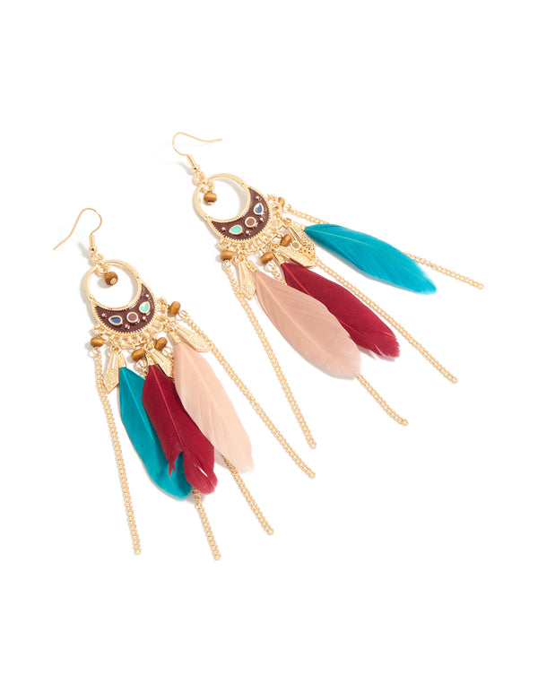 Showcasing statement drop earrings with beads, charm, and feathers in gold front view