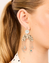 Designed with brushed gold rainbow and celestial charm drop earrings in a statement style, featuring moon, pearl, star, sun, hamsa hand, and snake charms on ear view - link has visual effect only
