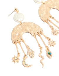Featuring brushed gold rainbow and celestial drop earrings with statement style featuring pearl, evil-eye, hamsa hand, snake, moon, sun, star charms with pearl close up view - link has visual effect only