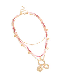 Discover a gold pink beaded and celestial layered necklace with charm featuring sun and heart in a statement design front view - link has visual effect only