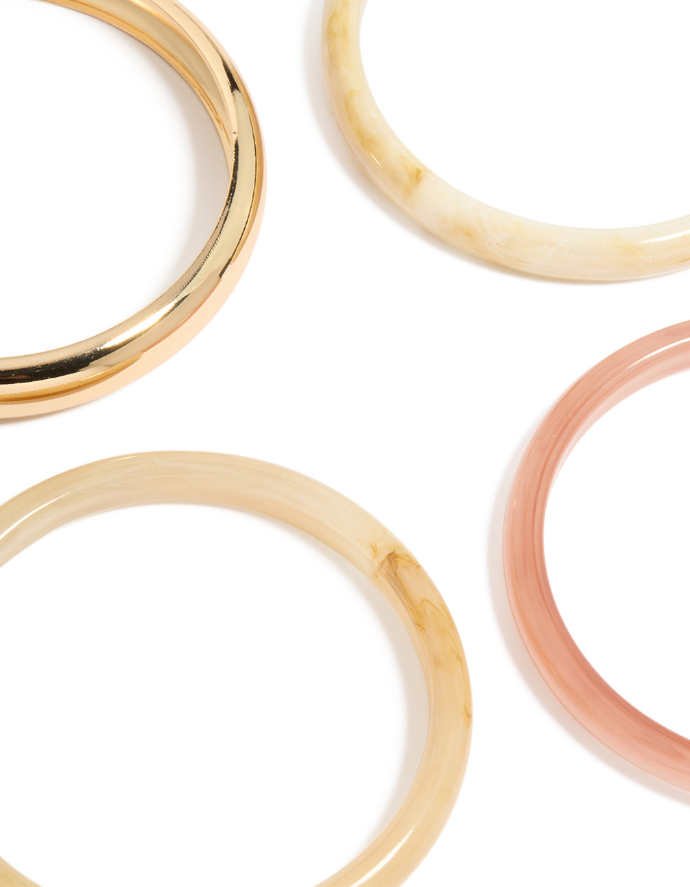Featuring gold and pink acrylic bangles in a 4-pack set close up view