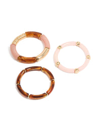 Showcasing a beaded charm stretch bracelet 3-pack crafted from resin in pink and gold front view - link has visual effect only