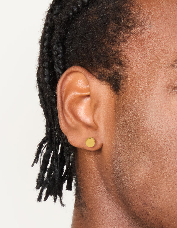 Showcasing mens waterproof gold plated stainless steel round flat back studs on ear view