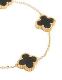 Designed with waterproof gold plated stainless steel black clover chain bracelet featuring charm accents in a dainty style close up view - link has visual effect only