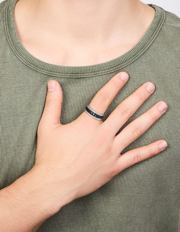 Featuring a mens waterproof stainless steel band ring with black chain detail in silver on finger view