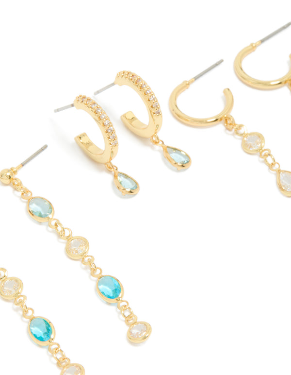 Showcasing gold plated blue and clear cubic zirconia stacking earrings 4-pack with crystal huggie and stud closures close up view