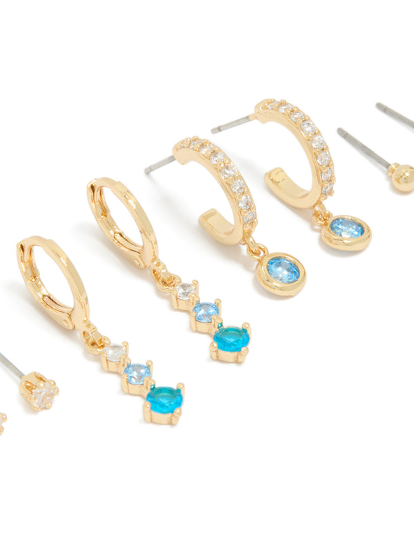 Showcasing gold plated clear and light blue cubic zirconia stacker earrings 4-pack with crystal details in huggie and stud styles close up view