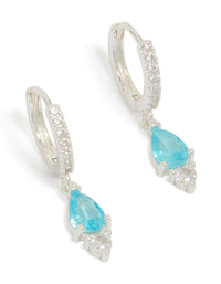 Elegant silver plated cubic zirconia blue huggie drop earrings featuring crystal accents with hoop closure in aqua front view - link has visual effect only