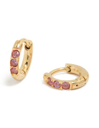 Featuring waterproof gold plated stainless steel huggie earrings with pink cubic zirconia stones front view - link has visual effect only