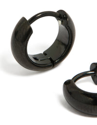Showcasing statement chunky huggie earrings crafted from waterproof black coated stainless steel close up view - link has visual effect only