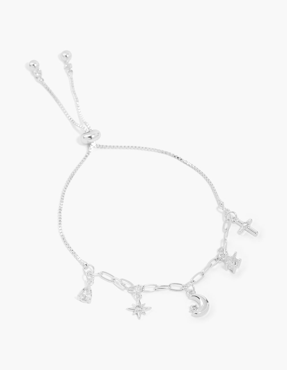 Celestial charm toggle bracelet crafted from silver plated material featuring moon, star, and cross details front view