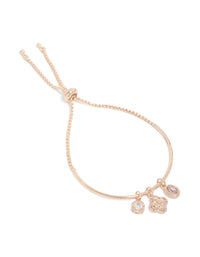 Showcasing a rose gold plated cubic zirconia flower charm toggle bangle front view - link has visual effect only