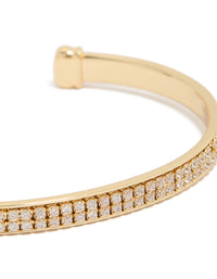 Elegant wrist cuff in gold plated finish with cubic zirconia flat bezel settings close up view - link has visual effect only