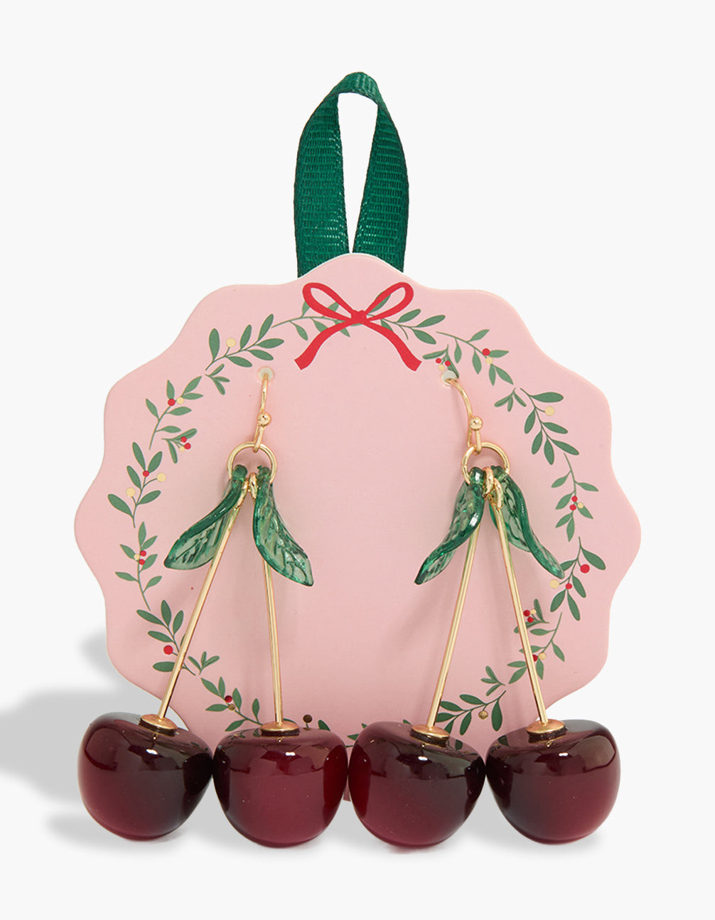 Showcasing statement drop earrings featuring charm, fruit, and leaf accents in gold front view