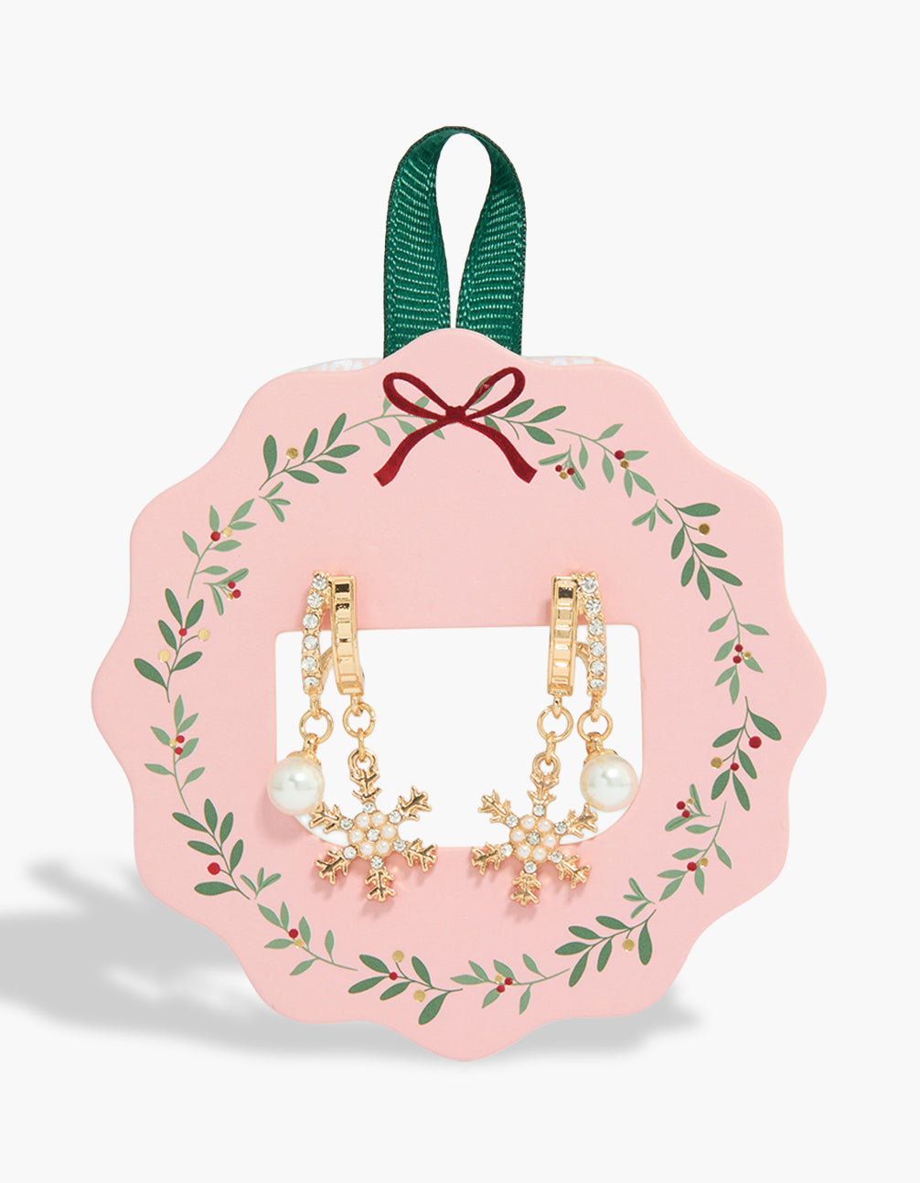 Showcasing gold snowflake and pearl double huggie earrings with charm detailing in a chunky style front view
