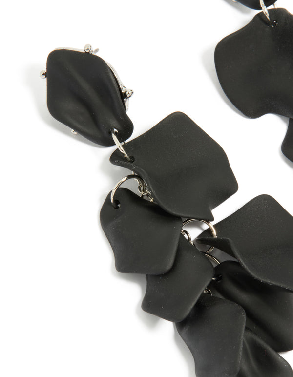 Beautifully crafted statement black coated metal petal drop earrings close up view