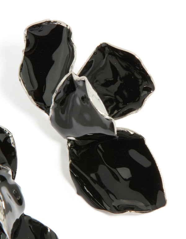 Showcasing dainty mini petal drop earrings with floral design in black coated metal and silver finish close up view