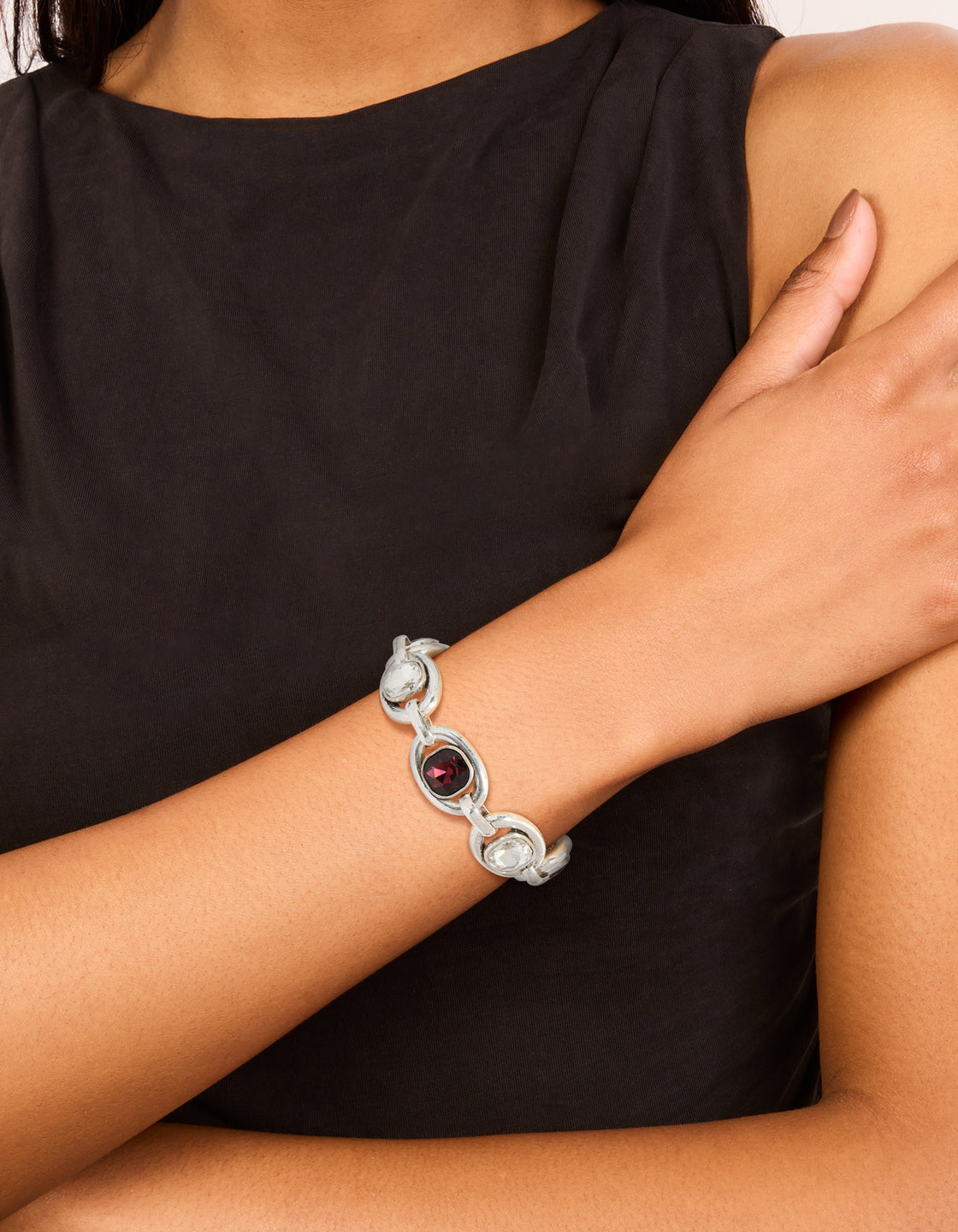 Featuring a chunky silver clear and burgundy diamante drop bracelet on wrist view