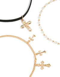 Highlighting gold textured cross and plain black choker necklaces set with beaded pearl charm details close up view - link has visual effect only