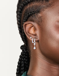 Showcasing stainless steel cubic zirconia mixed drop hoop earrings 3-pack featuring crystal waterproof material with stud closure in silver and clear on ear view - link has visual effect only