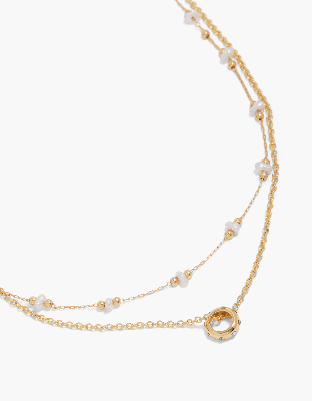 Showcasing a gold plated pearl and diamante circle double layered necklace with balls close up view