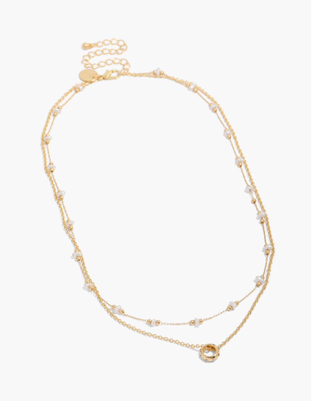 Showcasing a gold plated pearl and diamante circle double layered necklace with balls close up view
