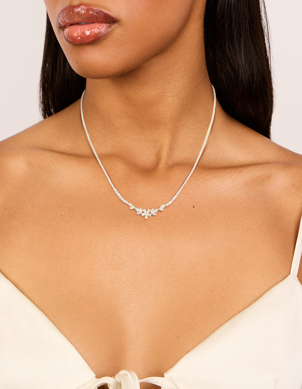 Showcasing a silver plated cubic zirconia dainty floral cupchain necklace details on neck view