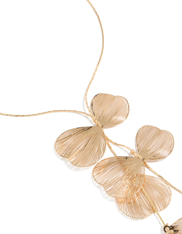 Showcasing a laser cut petals Y-necklace with statement style in gold close up view