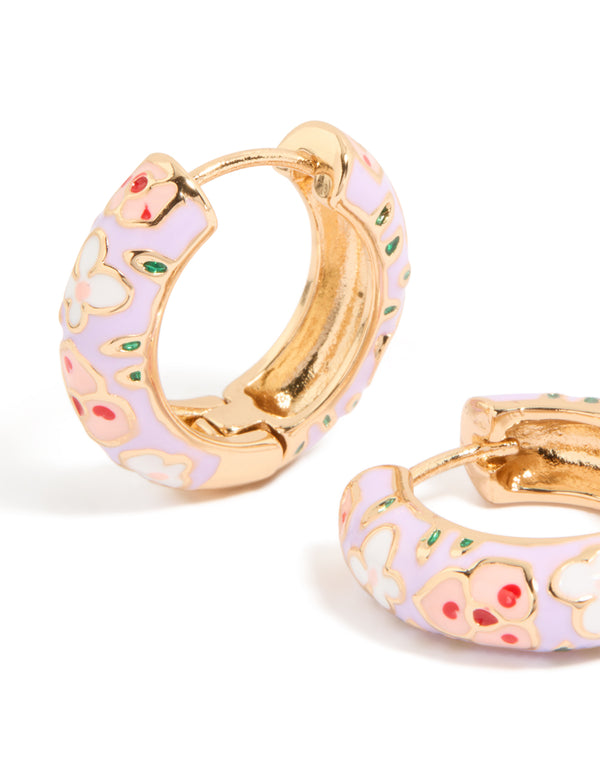 Displaying thick huggie earrings with floral enamel in gold, lilac, and pink close up view