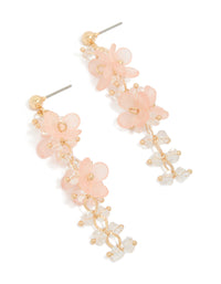 Showcasing statement drop earrings featuring beaded charms with floral in pink and beige front view - link has visual effect only